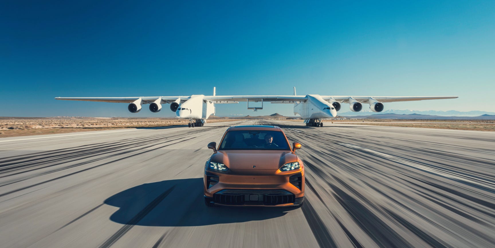 Watch a Porsche Cayenne Electric Keep Pace With the World's Largest Flying Plane